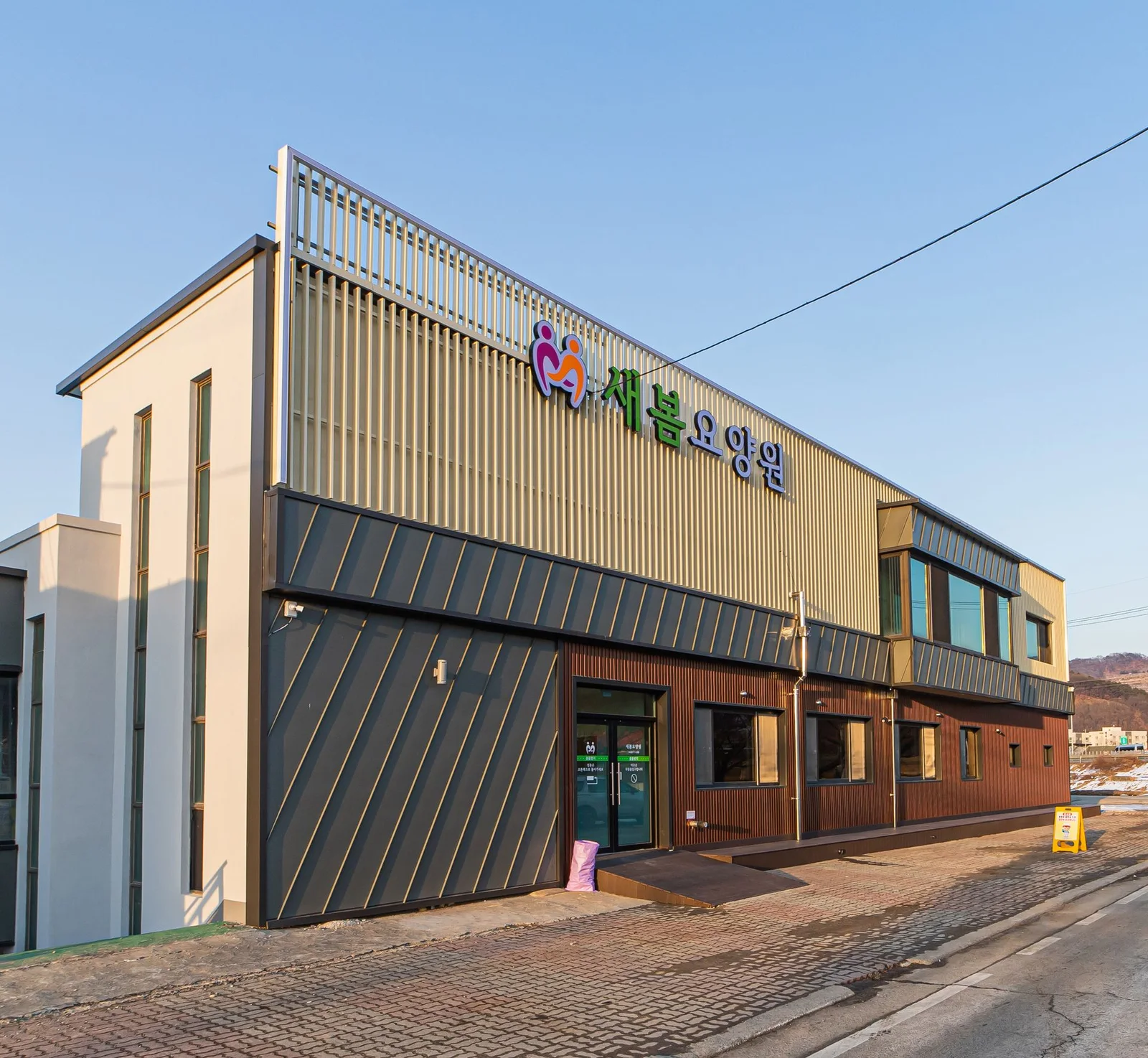 새봄요양원 간판과 출입구가 보이는 건물 외관